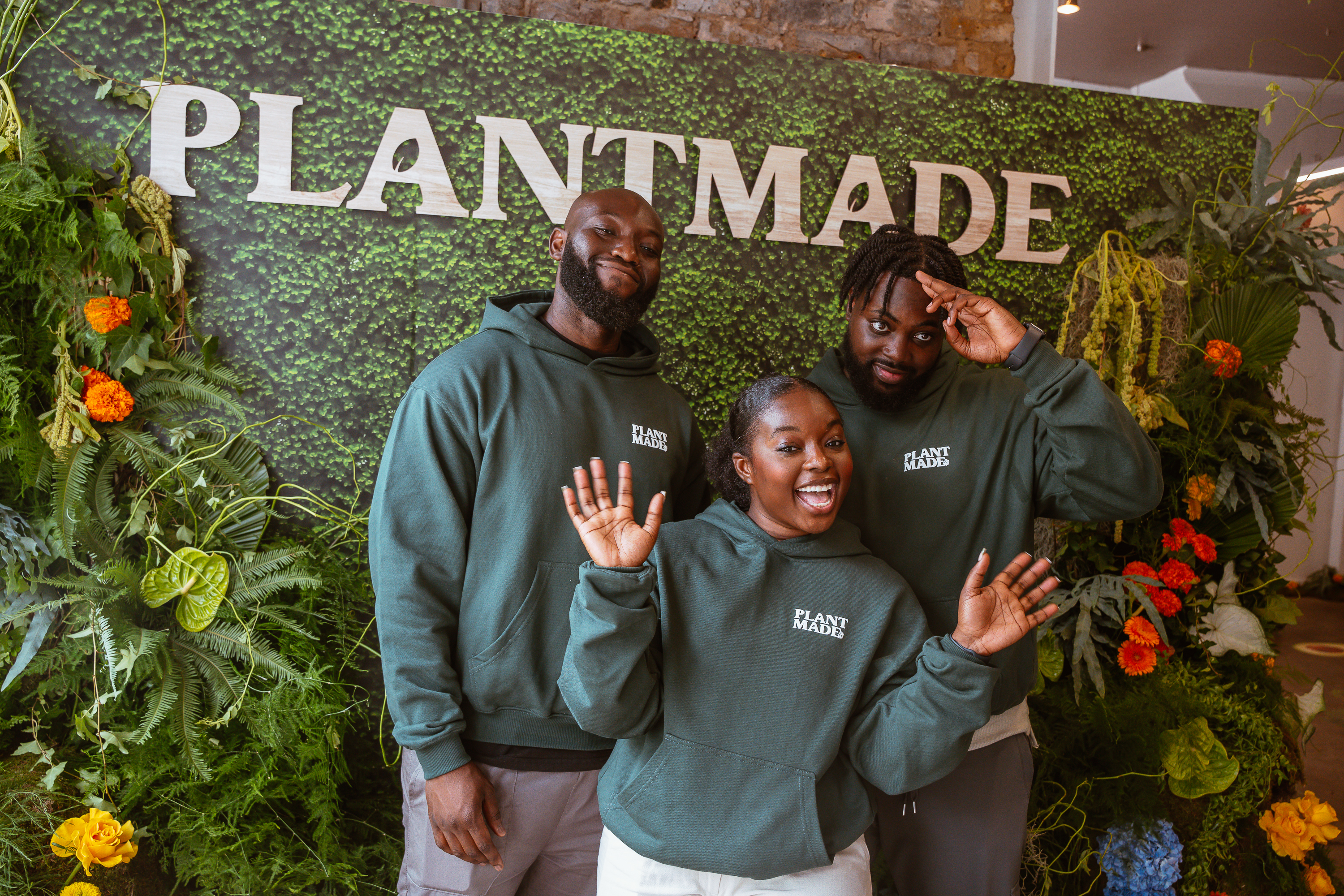 Ama Amo-Agyei and the Plantmade founding team in branded hoodies, in front of the Plantmade signage